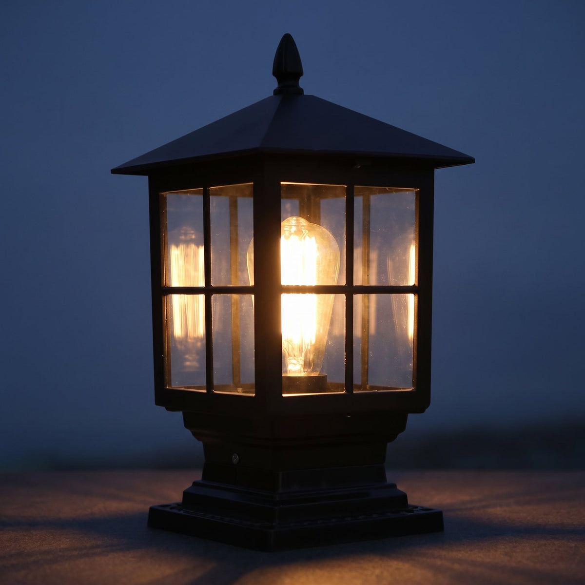 Black solar post light with traditional lantern design mounted on a gatepost