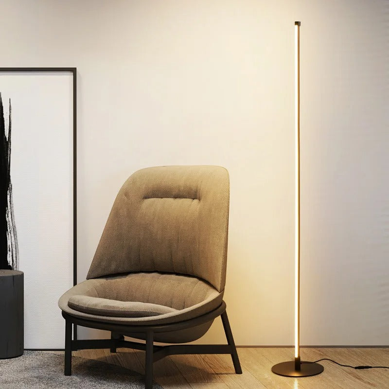 Metal floor lamp glowing with warm white LED light in the evening