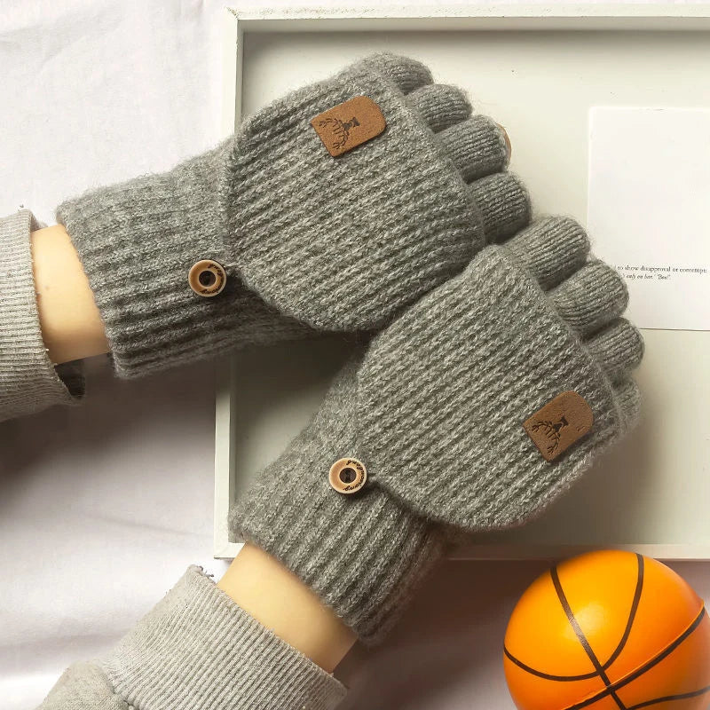 Hands in gray fingerless knit gloves scrolling on a smartphone