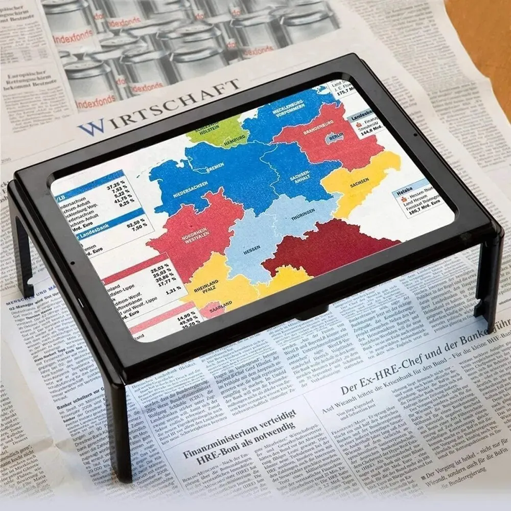 Hands free reading magnifier standing over an open book