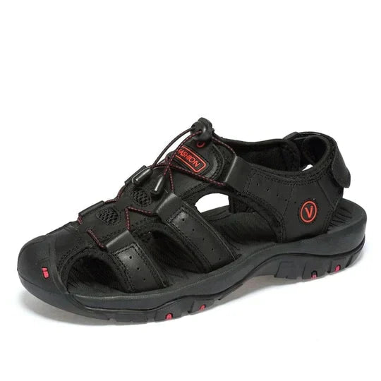 Men's closed toe hiking sandals with rubber sole on a rocky trail
