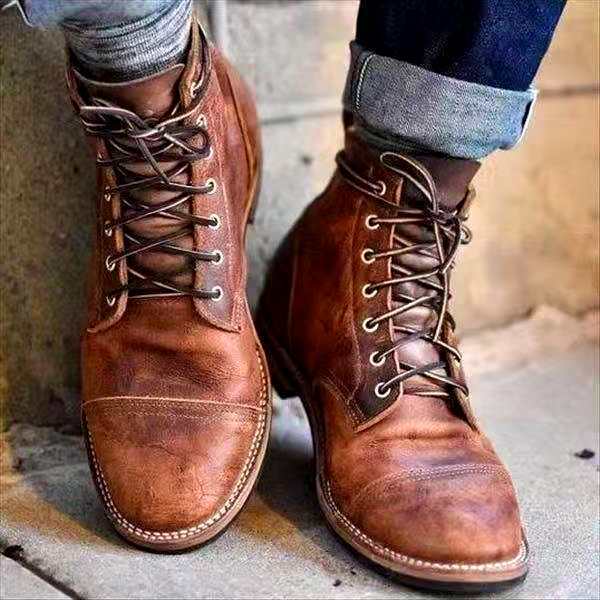 Pair of men's retro lace up boots in brown with a treaded sole
