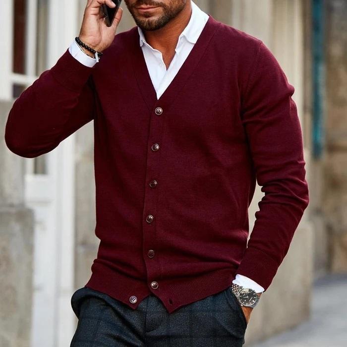 Man wearing a dark V neck cardigan with button front over a shirt