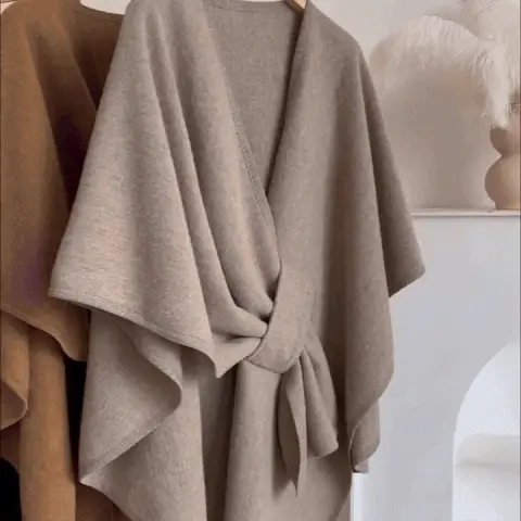 Khaki poncho worn closed like a coat