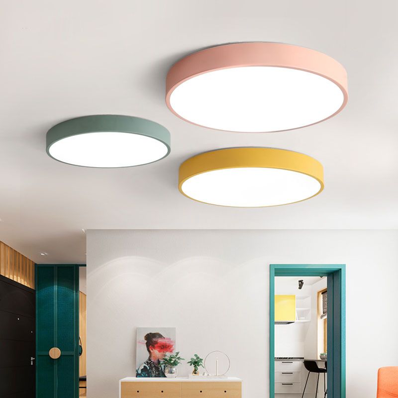 Round modern LED ceiling light mounted in a living room