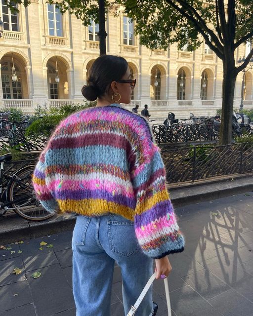 Woman wearing a cropped color block sweater with high-waisted pants