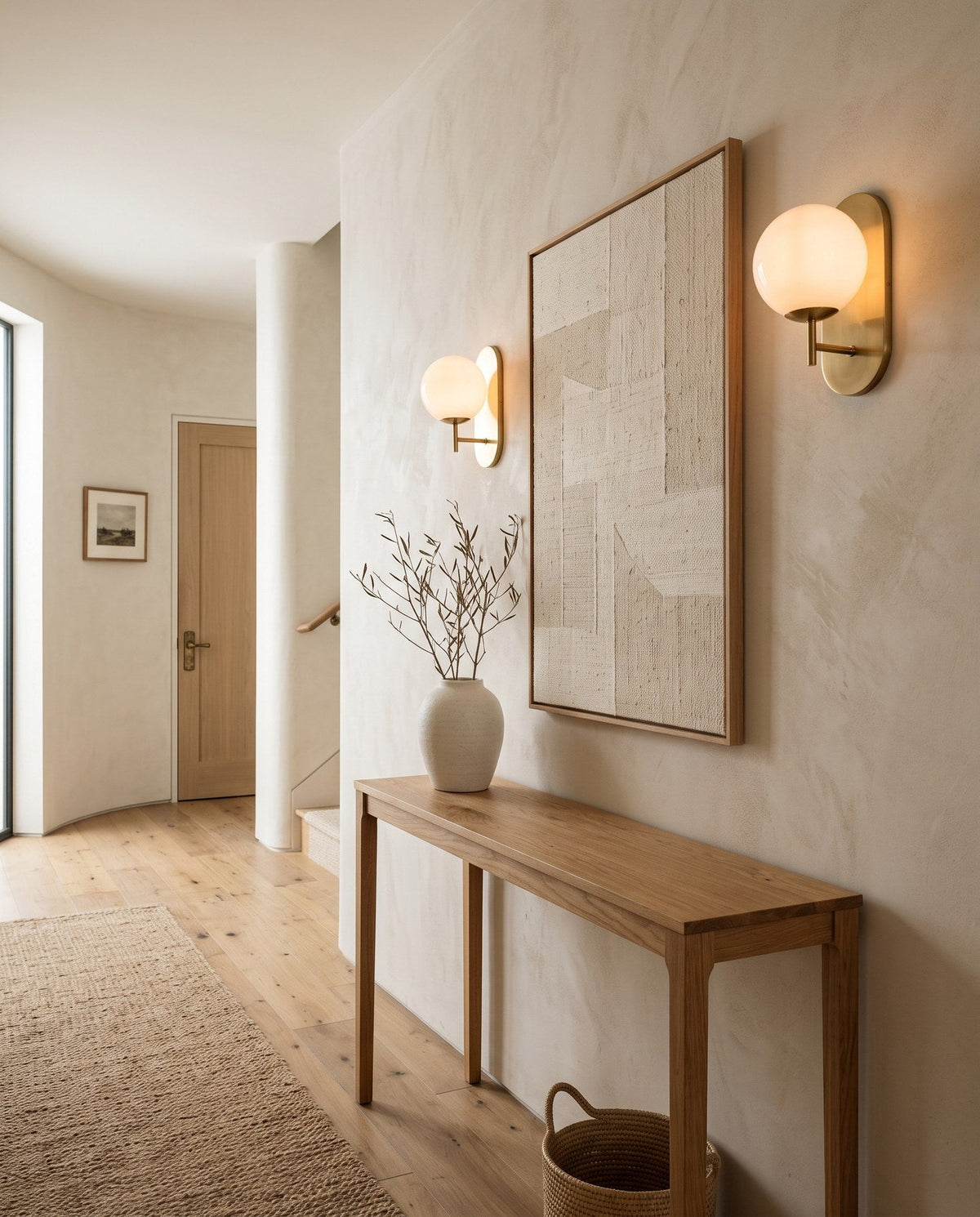 Pair of opal glass wall lights above an oak console