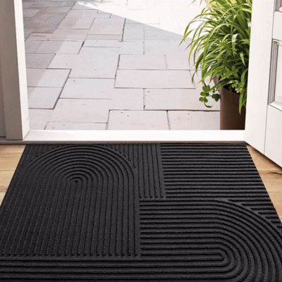 Absorbent door mat with a flowing line pattern in an entryway