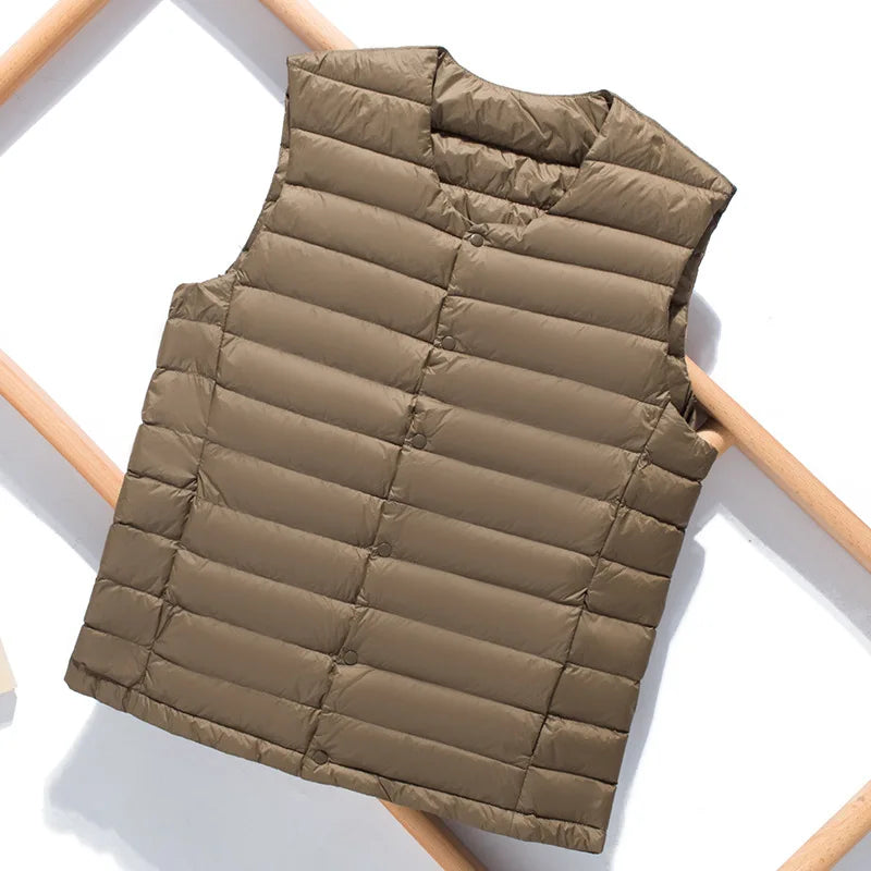 Multiple color options of the men's packable down vest lined up side by side.