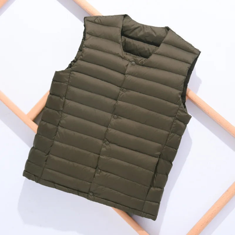A man working outdoors with full arm mobility while wearing the sleeveless down vest.