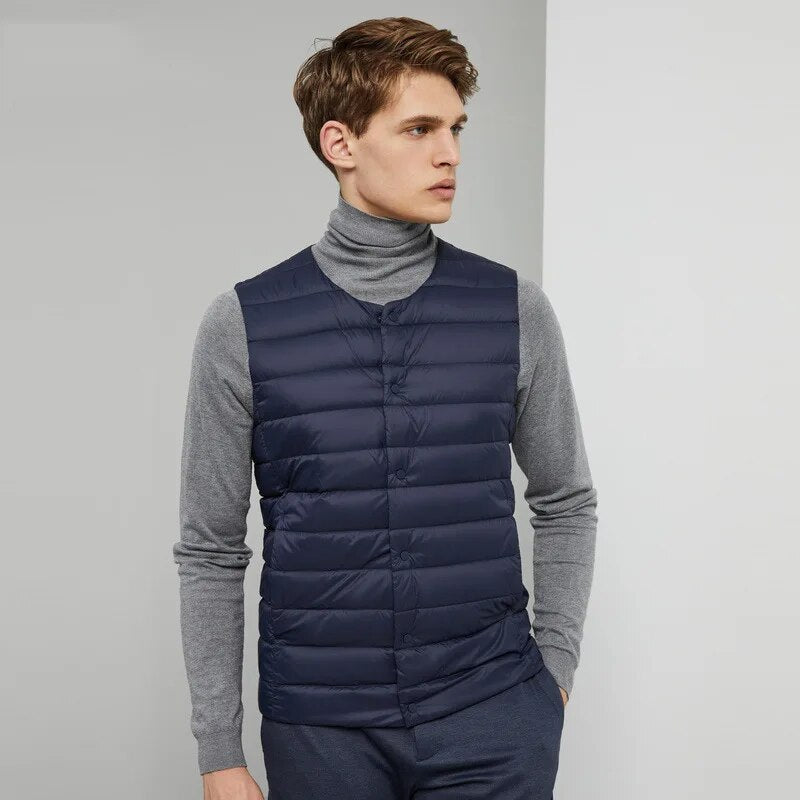 The packable down vest compressed and folded into its compact travel carrying pouch.