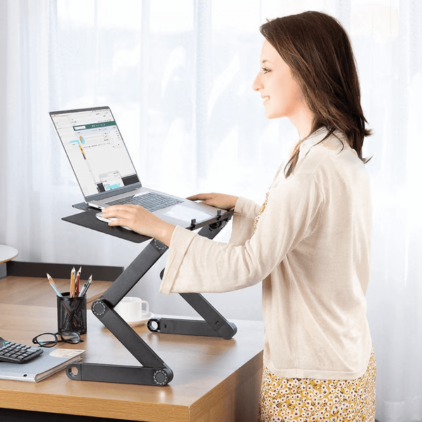 Aluminum laptop stand with rotating legs raising a laptop on a desk