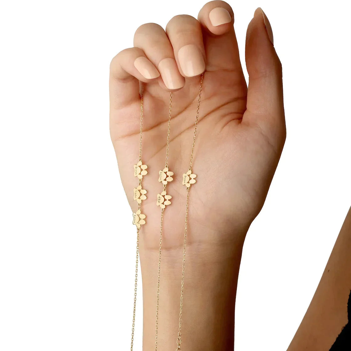 Personalized paw print bracelet in silver, gold, and rose gold finishes with custom engraved dog names.