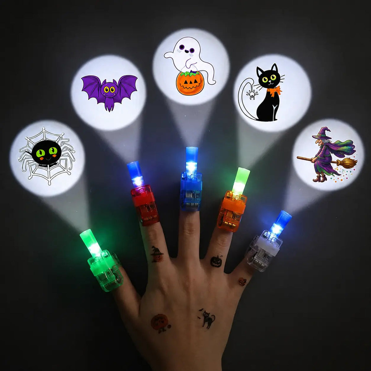 Child wearing an LED finger projector ring that shines a Halloween design on the wall