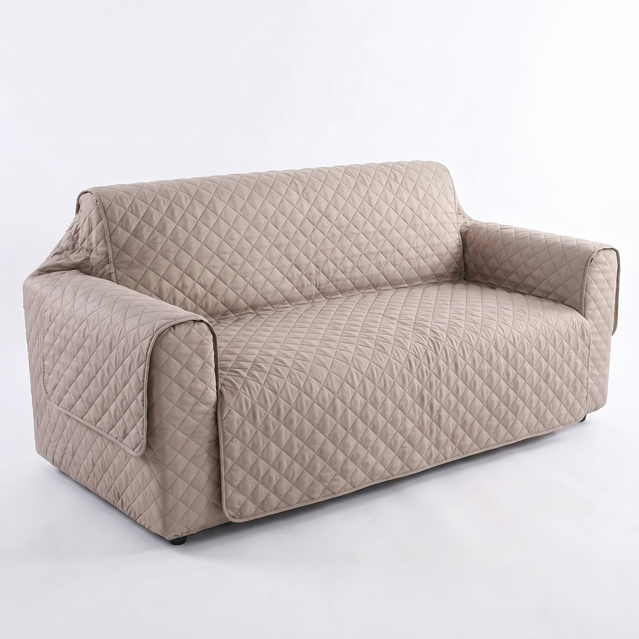 Light tan waterproof quilted sofa cover, studio product photo
