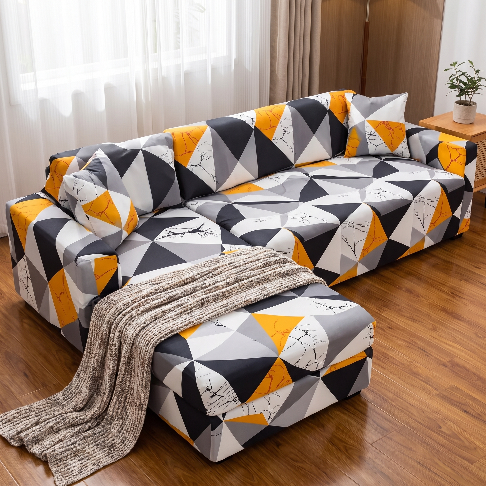 Stretch Sectional Couch Cover – Orange Black Geometric Mosaic shown in a styled home interior | Brivenzo