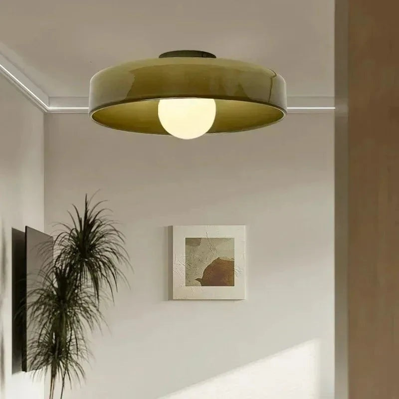 Ceiling light with a tinted glass plate and white globe hanging below
