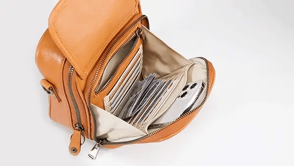 Compact crossbody bag worn across the body on a busy street