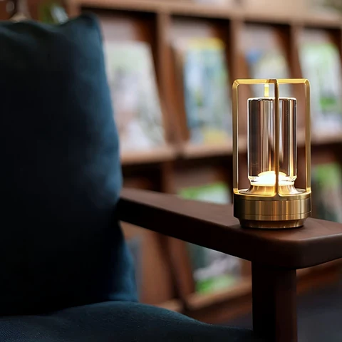 Cordless metal table lamp glowing on a dining table