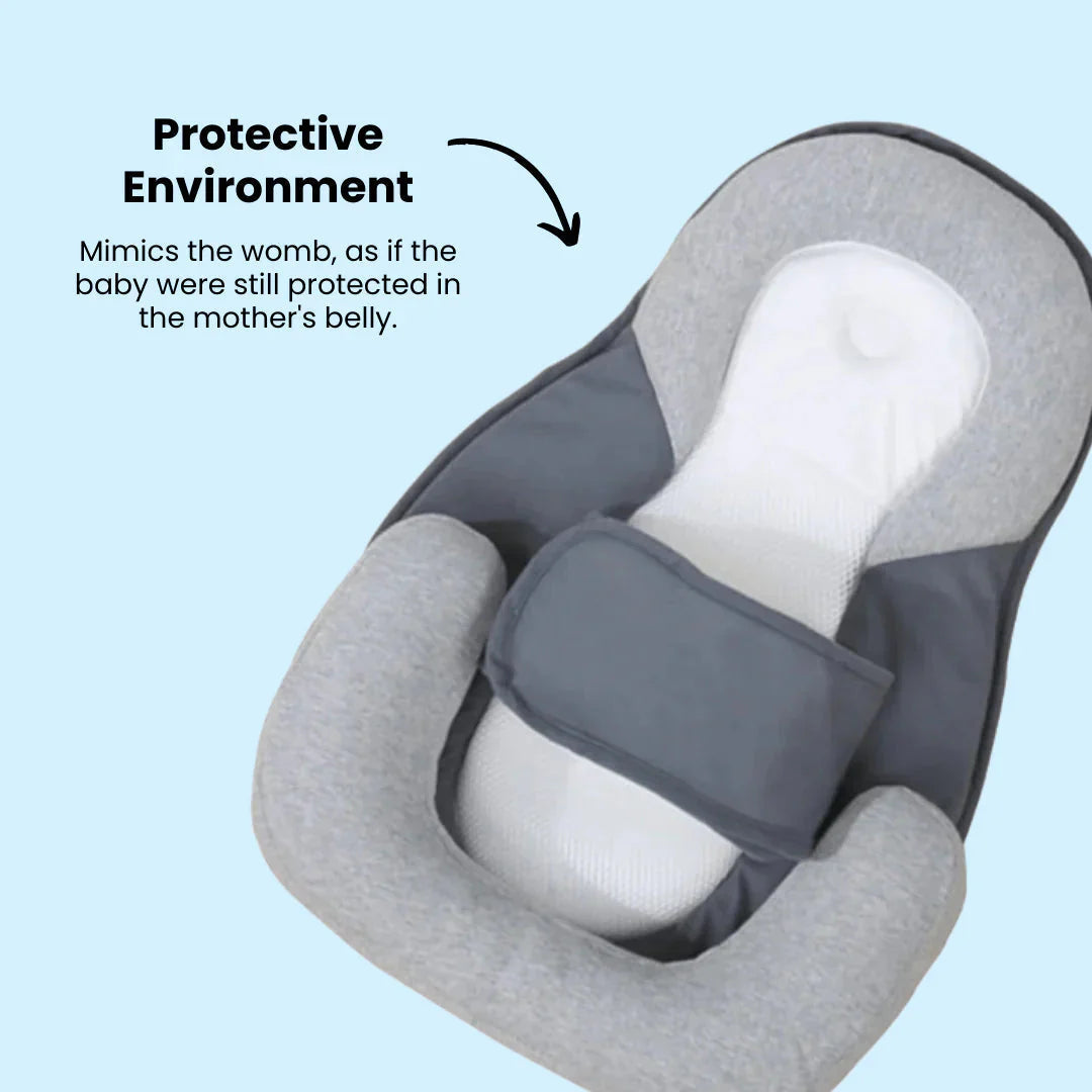 Baby pillow placed in a crib next to a soft blanket