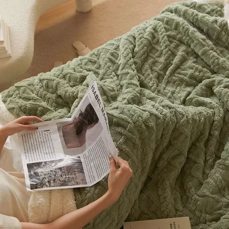 Soft faux lambswool blanket draped over a bed