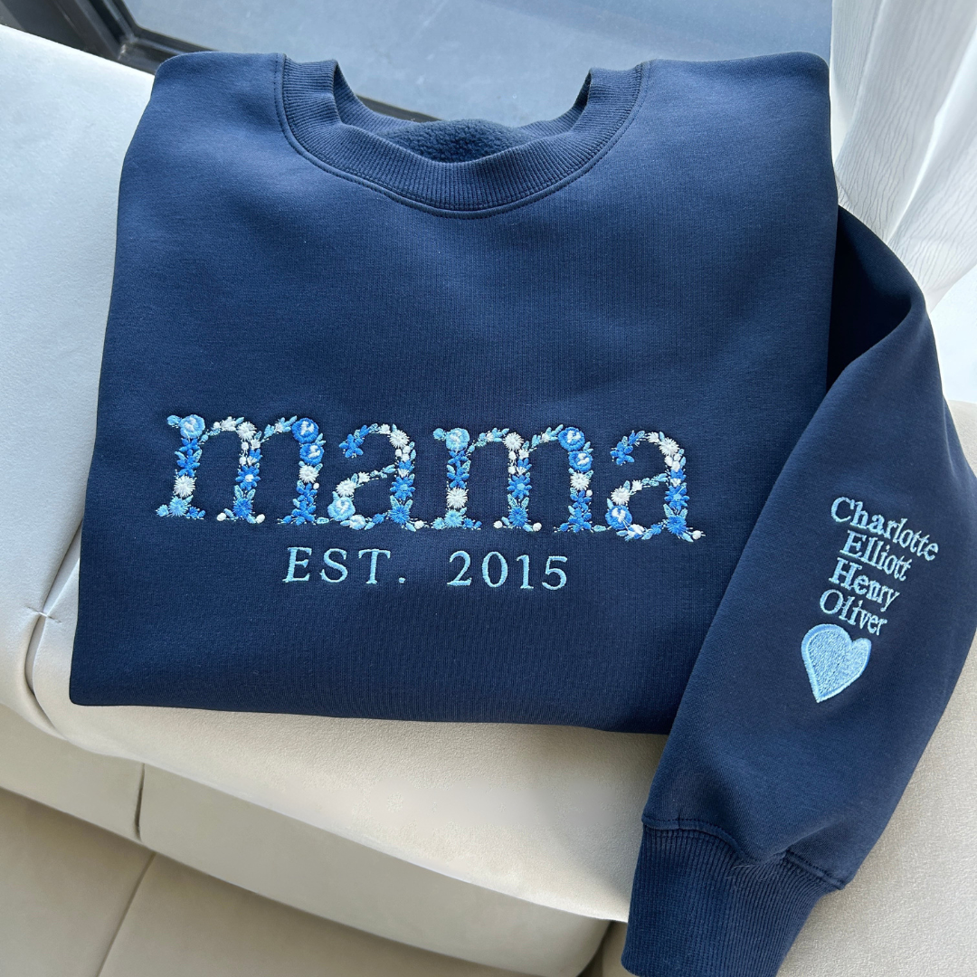 Close-up of the dense, intricate floral embroidery on the custom mom sweatshirt showing detailed stitching.