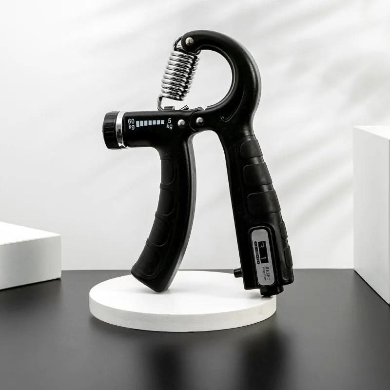 Hand grip strengthener being squeezed with adjustable resistance dial