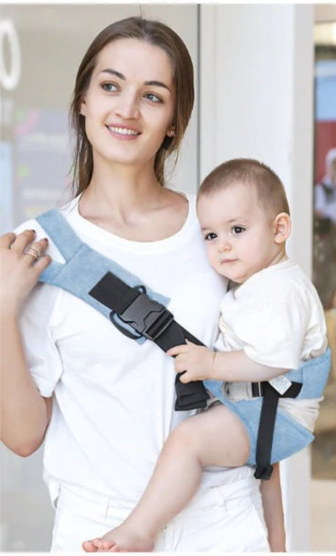 Woman wearing the blue hip seat baby carrier