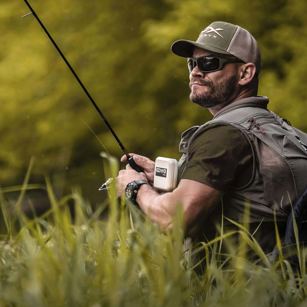 Angler wearing polarized sport sunglasses while fishing on a sunny lake.
