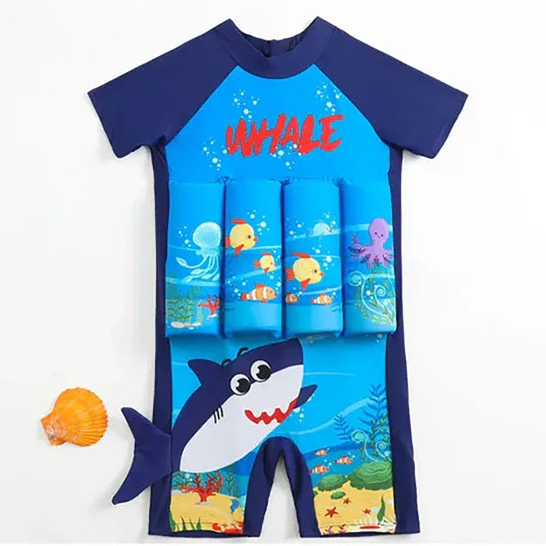 Child floating upright in a pool wearing a float swimsuit and swim cap