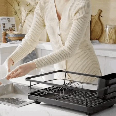 Large dish drying rack with plates and cups on a kitchen counter