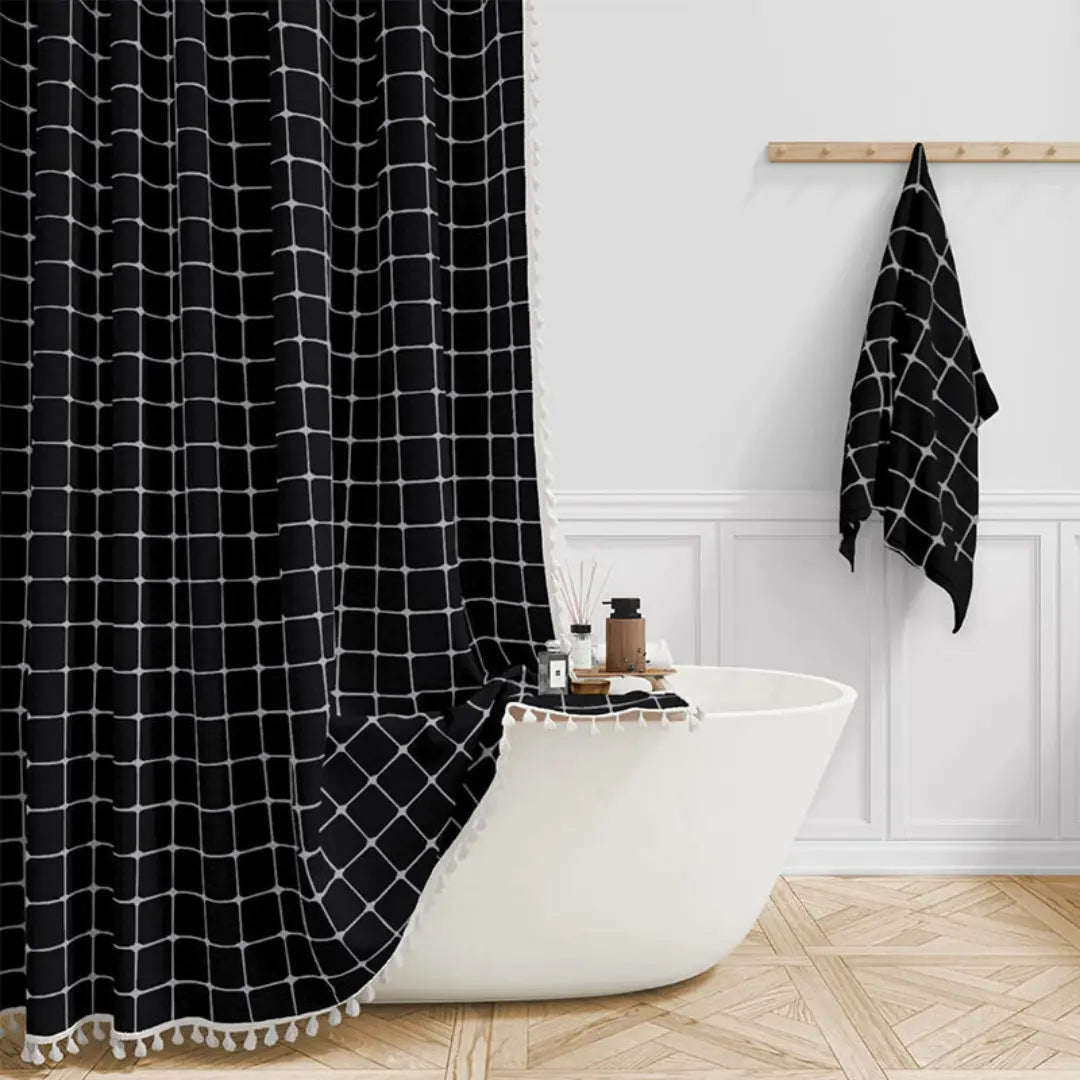 Close-up of the tassel hem and metal grommets of the shower curtain
