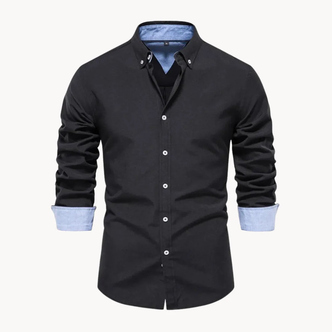 Man in a long sleeve button down shirt with a buttoned collar