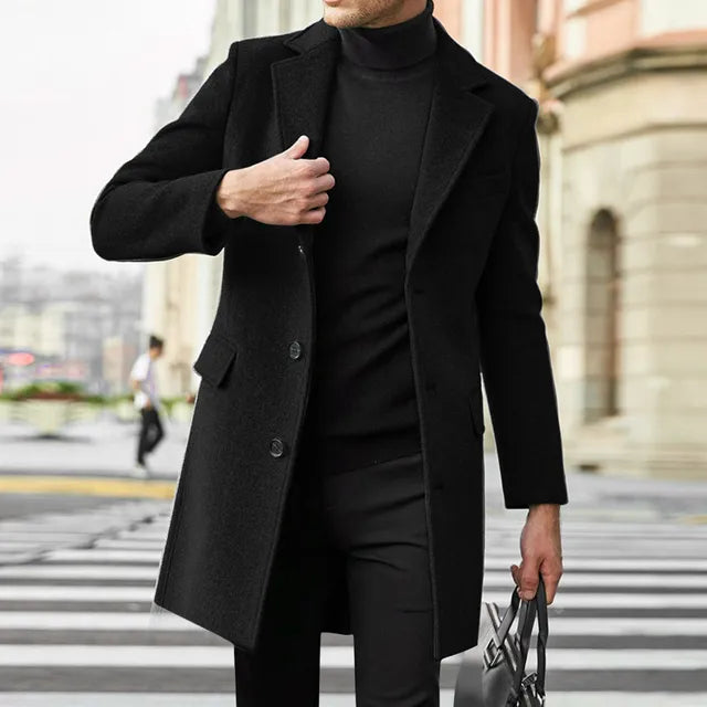Man wearing a long overcoat with notch lapel over a suit