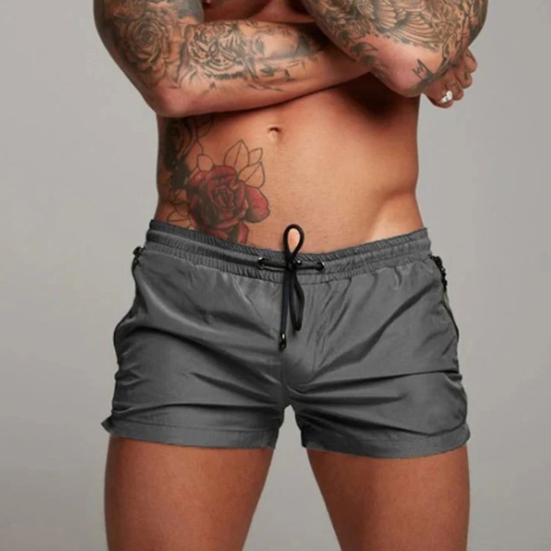 Man wearing quick dry swim trunks at the beach