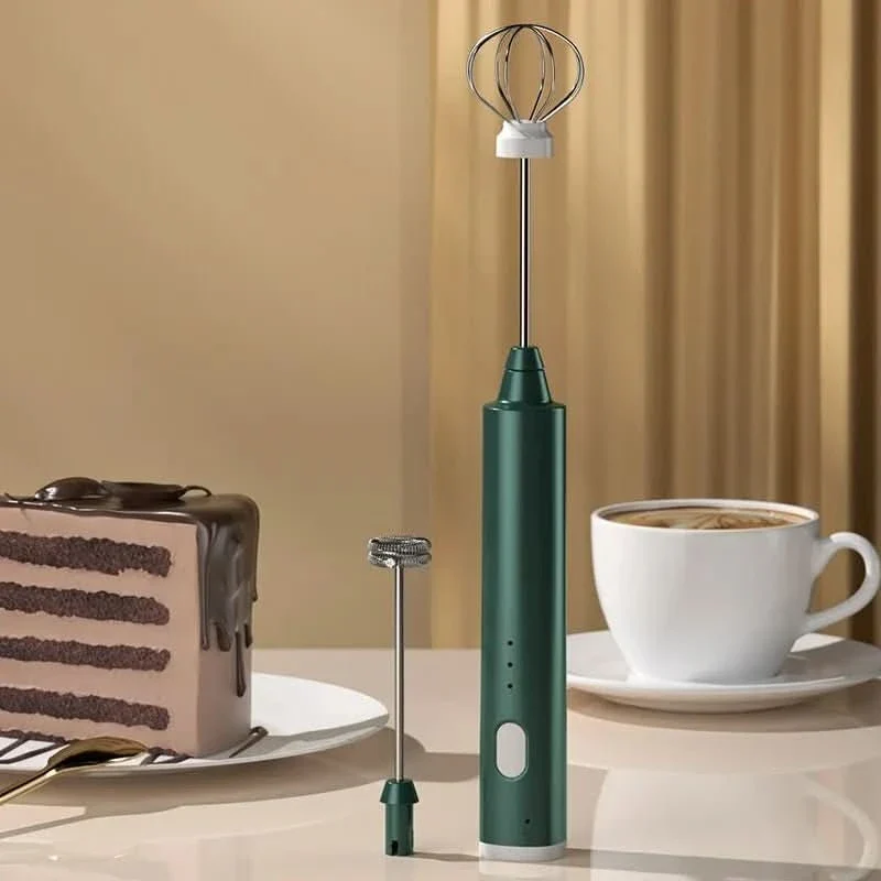 Mini hand mixer frothing milk in a coffee cup