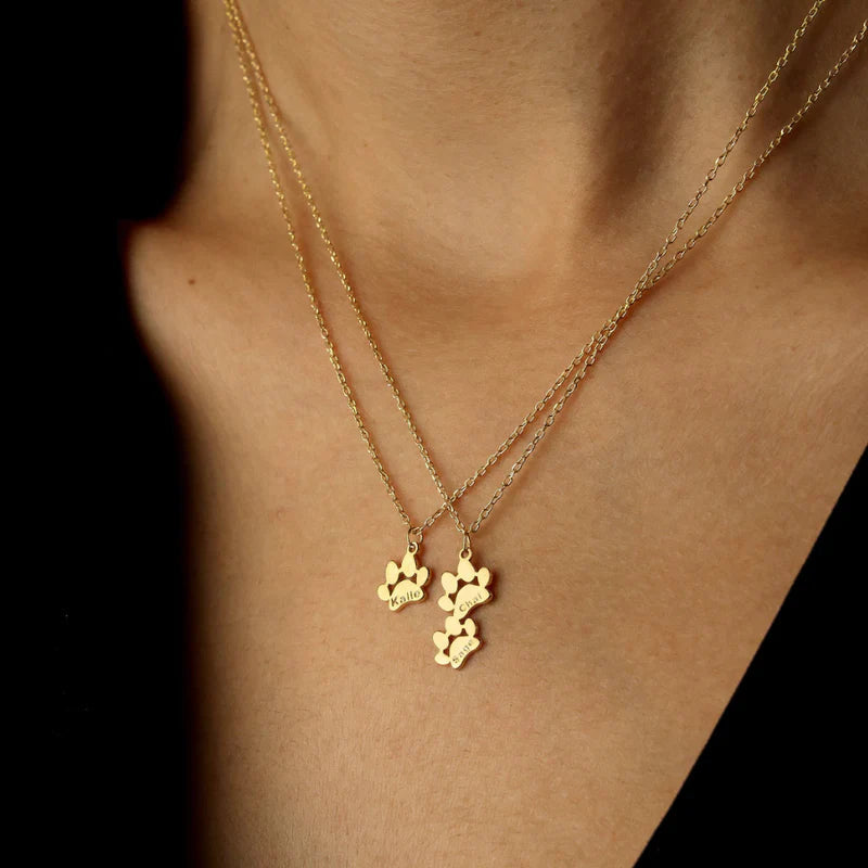Close-up of a tarnish-resistant silver dog paw charm featuring a cleanly engraved pet name.