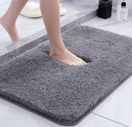 Plush gray microfiber bath mat in front of a shower