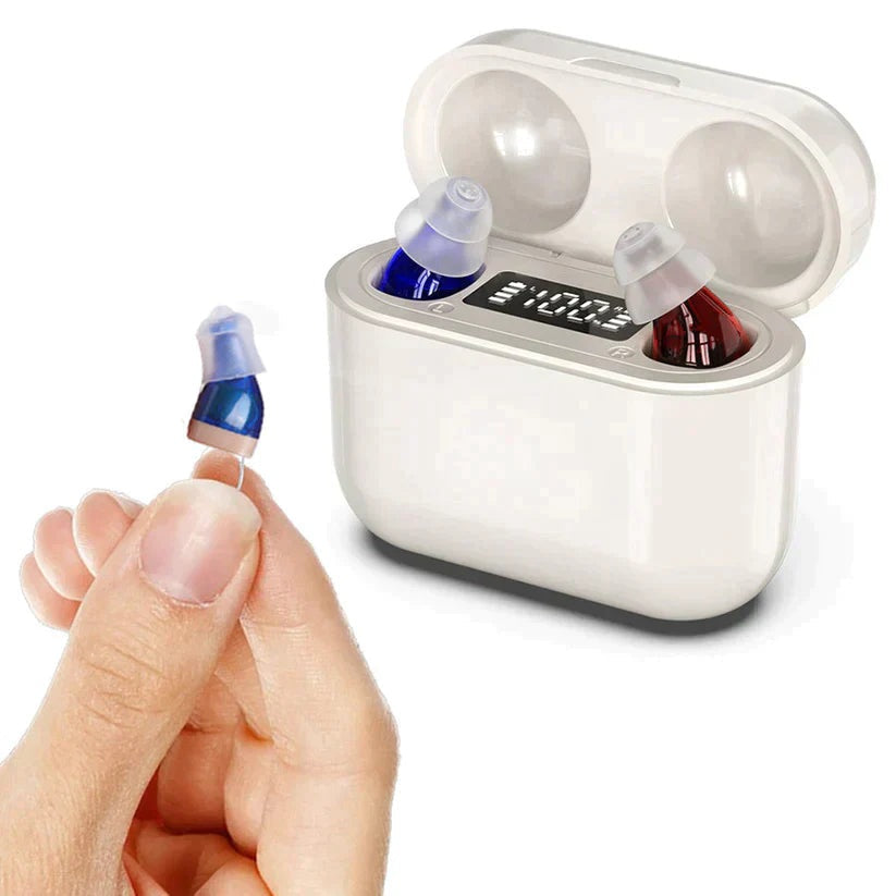 Pair of small in ear hearing amplifiers in their charging case