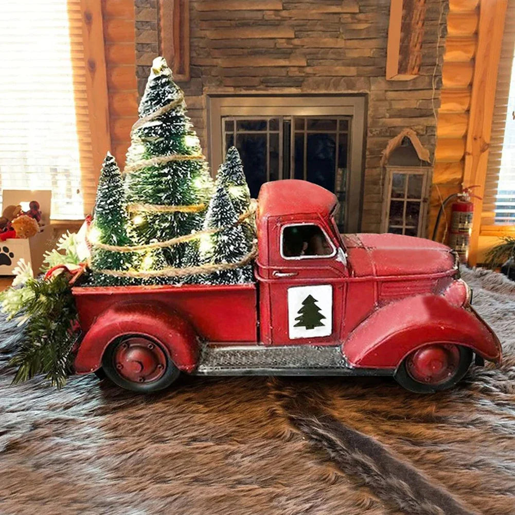 Red pickup truck ornament with a mini tree hanging on a Christmas tree