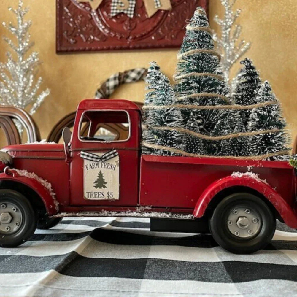 Red pickup truck ornament standing on a shelf as holiday decor