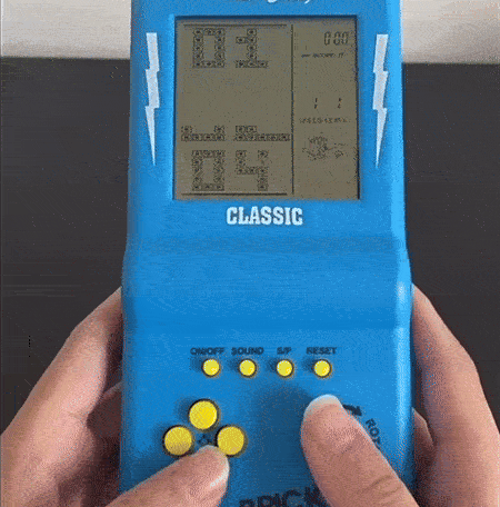 Retro handheld game console with a block puzzle game on screen