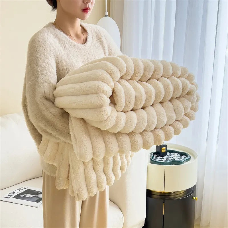 Ribbed faux fur throw blanket draped over a sofa