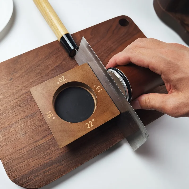 Rolling knife sharpener being used on a kitchen knife