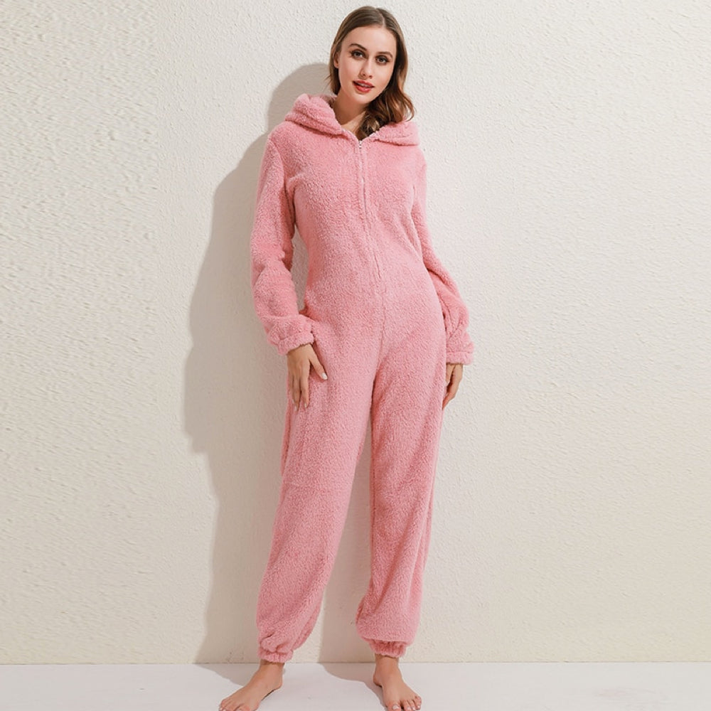 Person relaxing on the couch in a fleece onesie with bear ears