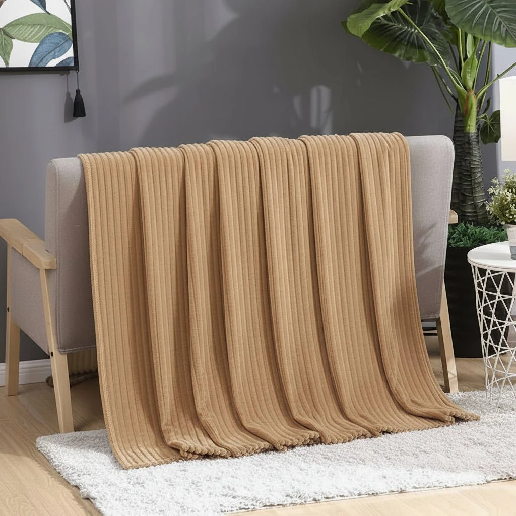 Close-up of the soft striped fleece blanket on a bed