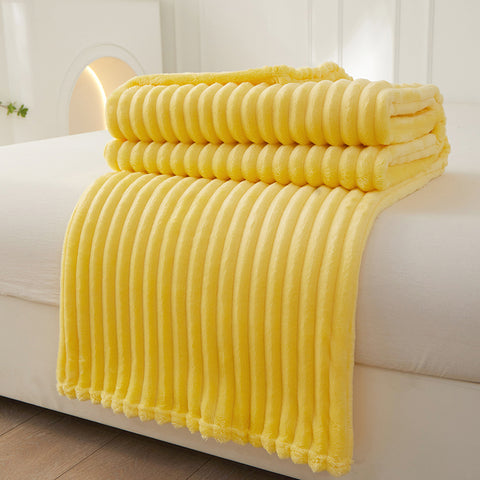 Striped flannel fleece blanket draped over a sofa