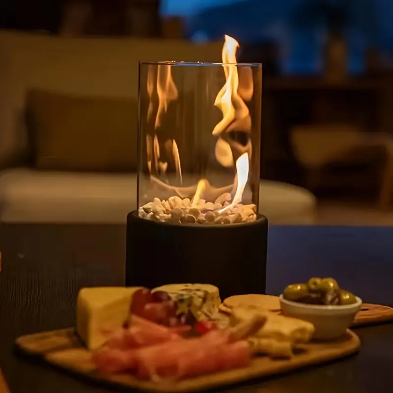 Black tabletop bioethanol fireplace burning on a dining table