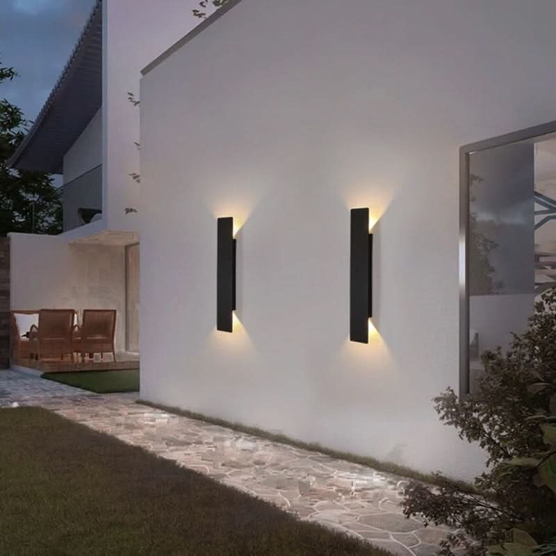 Black LED wall light on an exterior wall at dusk
