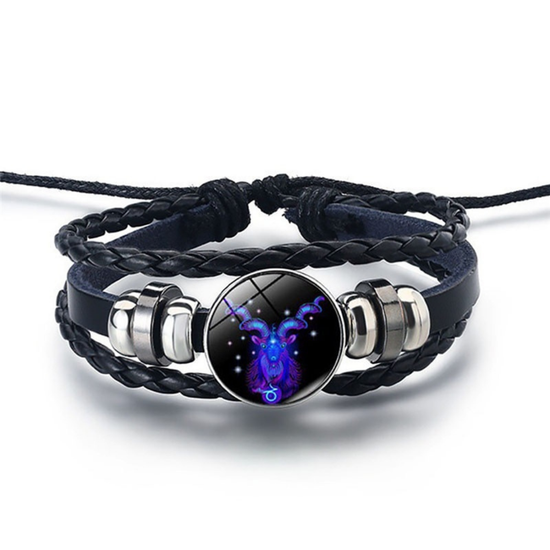 Main shot of two blue lapis lazuli zodiac sign bracelets with leather straps on a white background.